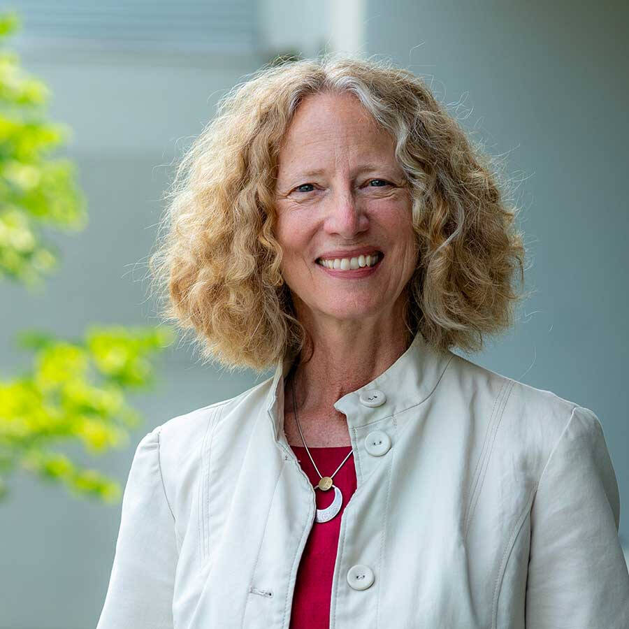 Dr. Drake outside of JHZ wearing an off-white jacket and red top